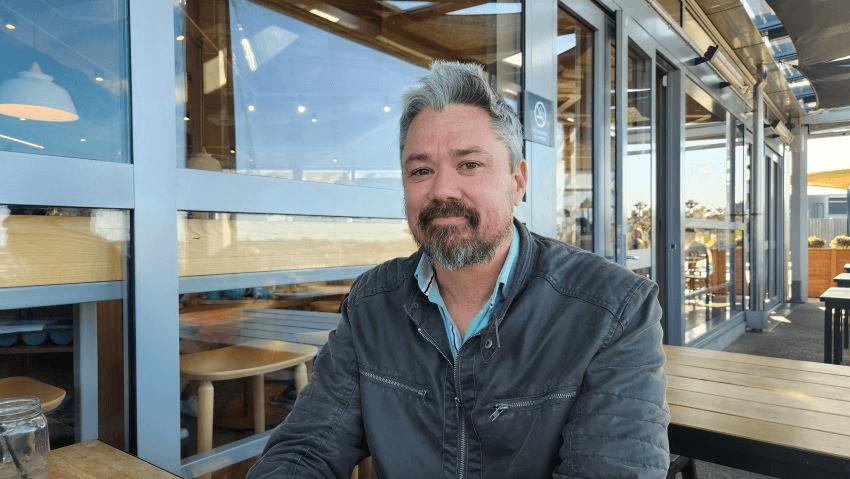 Sebastian Hurrell sitting at an Auckland cafe