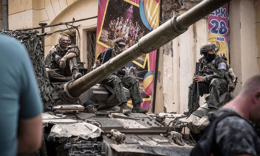 Wagner Group mercenaries sit on top of a tank in Rostov-on-Don on June 24, 2023 (Photo: Roman ROMOKHOV / AFP via Getty Images) 
