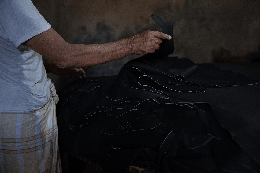 a hand in a dark black background, looking gritty and threatening