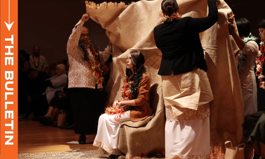 Jacinda Ardern is covered by a mat of forgiveness during a service in 2021 to make a formal apology to the Pacifika people affected by the Dawn Raids (Photo by Fiona Goodall/Getty Images)