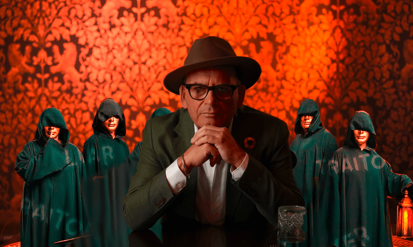 Paul Henry in a fedora with some traitors behind him