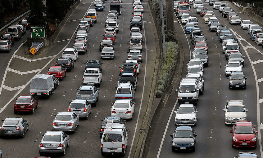 a long line of cars on a motorway in New Zealand for four lanes in each direction