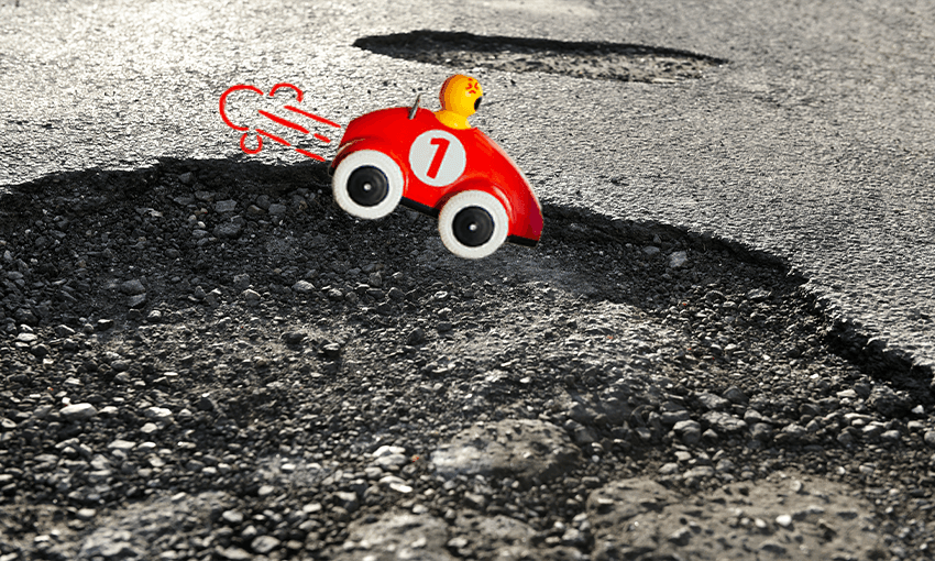 a pothole with a little cartoon and a guy looking annoyed