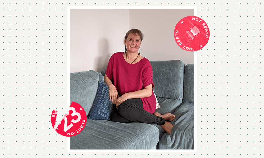 a woman wearing a red shirt sitting on a blue couch with a smile and a election 2023 spinoff logo on top