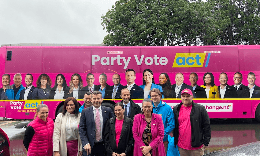 David Seymour and other Act candidates in front of a big pink bus