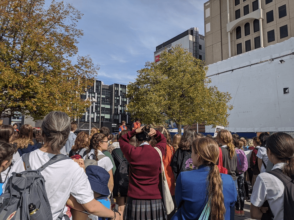 a whole lot of kids holding signs at a protest