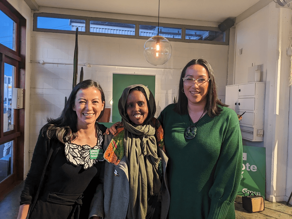 three women: lan, of veitnamese heritage on the left, sahra ahmed, of somalian heritage and wearing a hijab in he middle, and kahurangi carter, Māori and wearing a green dress on the right