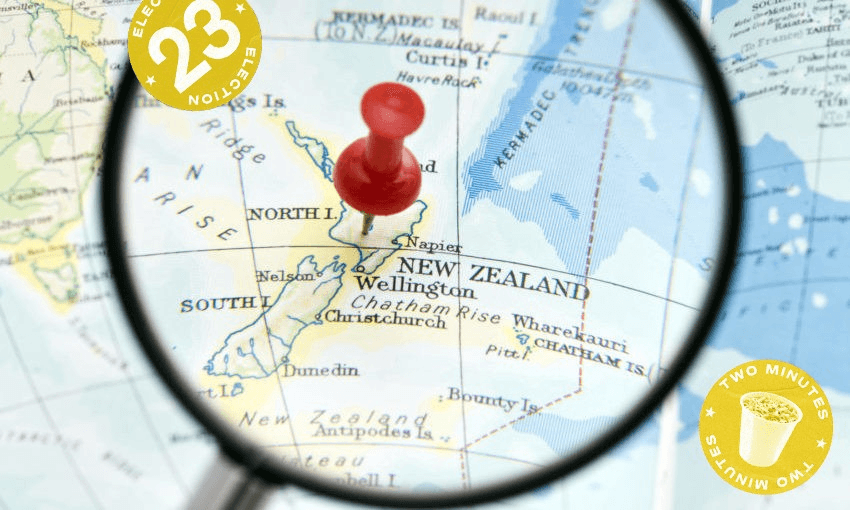 a pin in a map of New Zealand on a world map, a magnifying glass over the top