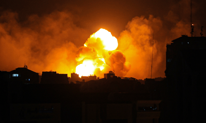 Fire and smoke rise above buildings in Gaza City during an Israeli air strike on October 8 (Photo: IBRAHIM HAMS/AFP via Getty Images) 
