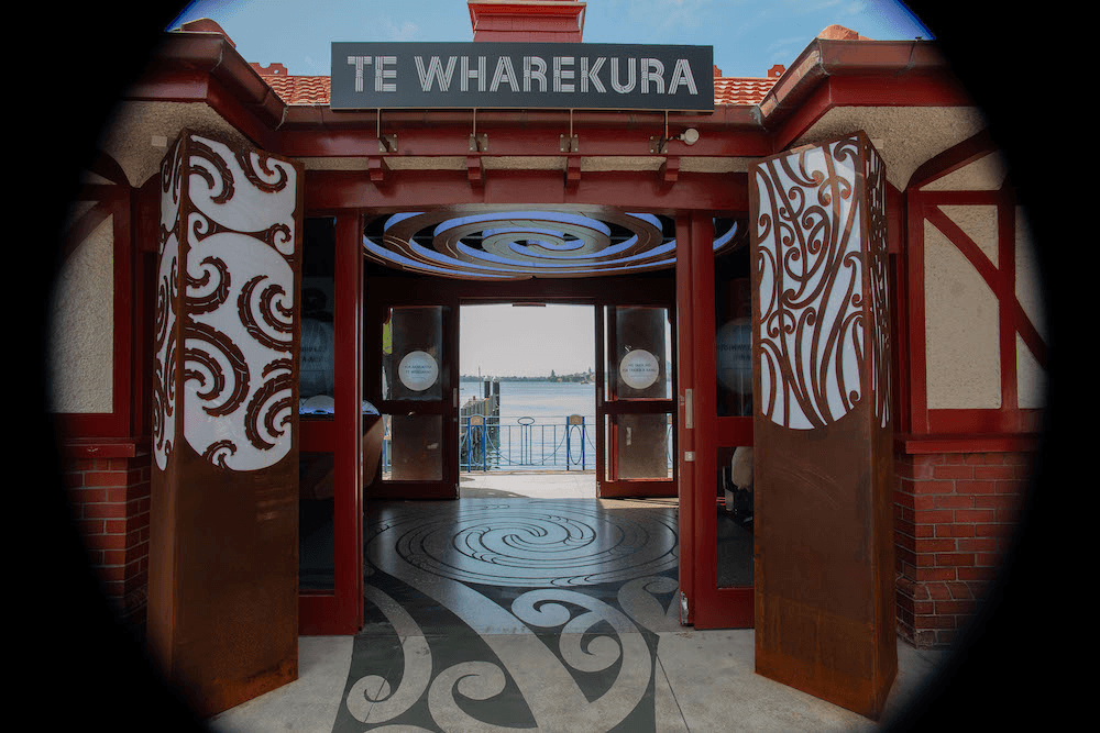 Two of the entrance pou and the takarangi.