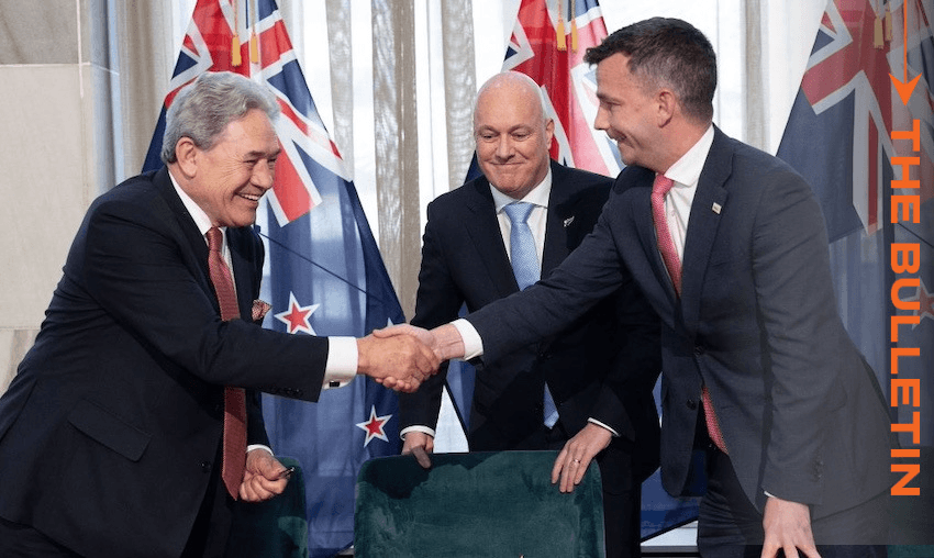 Winston Peters and David Seymour shake hands at Friday’s signing ceremony as Christopher Luxon looks on (Photo: Marty Melville / AFP via Getty Images) 
