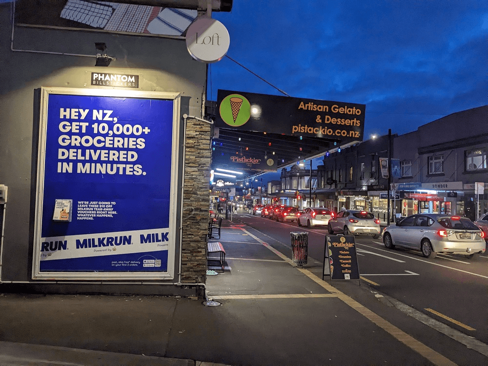 mount eden road at night with a blue milkrun poster
