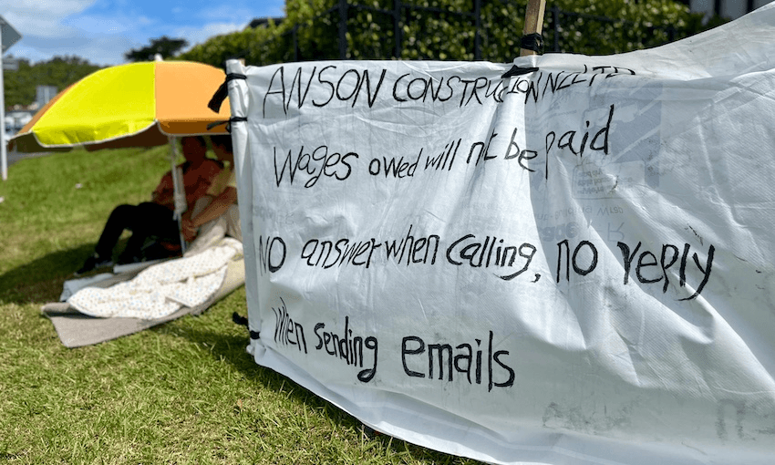 Ms Zhang and Guo Hua Huang outside the office of a company they say owes over $100,000 in wages to Huang and Zhang’s friend (Photo: Eda Tang) 
