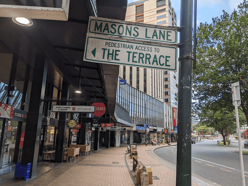 a photo of Mason's lane, on a paved lambton quay in central wellington