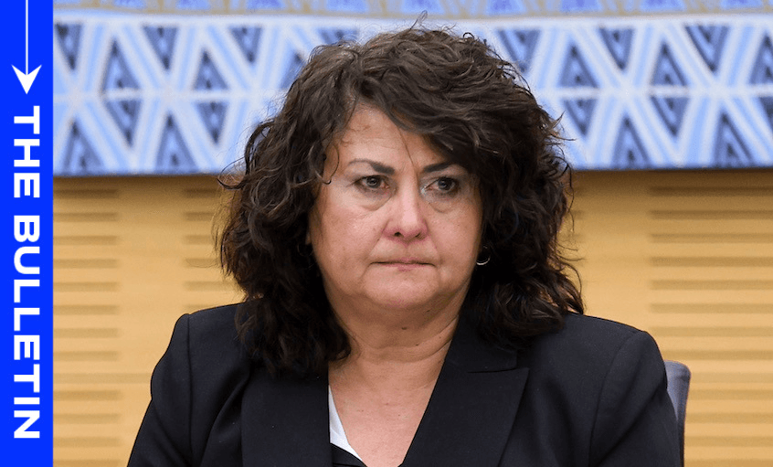 Casey costello a white woman with big brown hair looking rather grumpy and severe