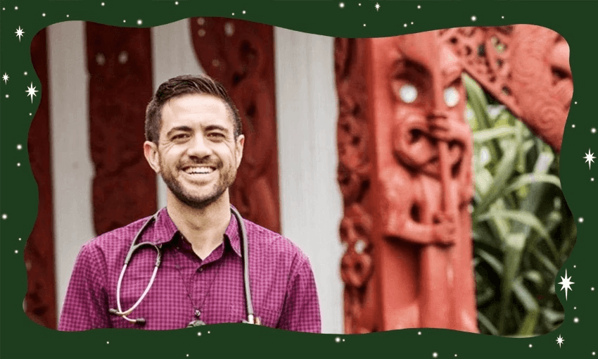 A smiling person wearing a purple checkered shirt and a stethoscope stands in front of traditional red carved wooden structures, framed by a green border with white star decorations.
