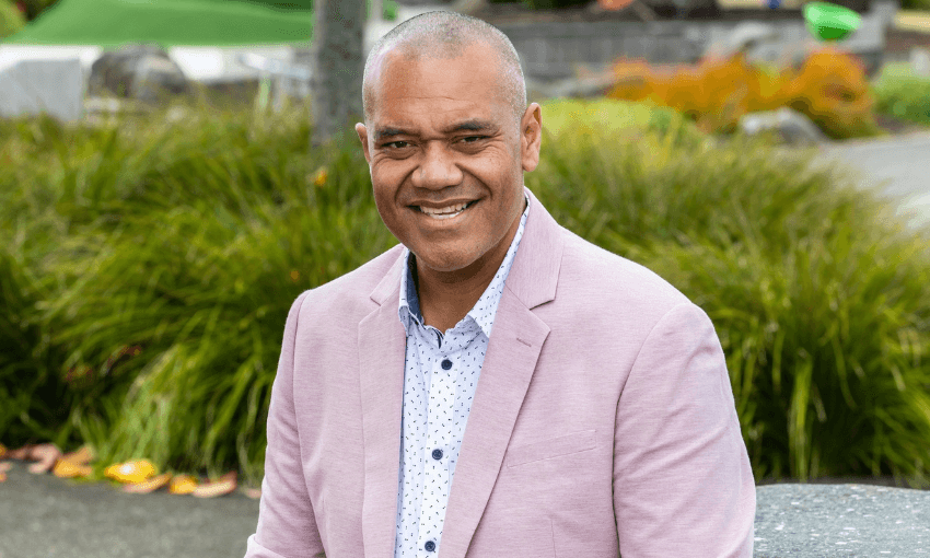 Efeso collins with a few bushes in the background a pink jacket