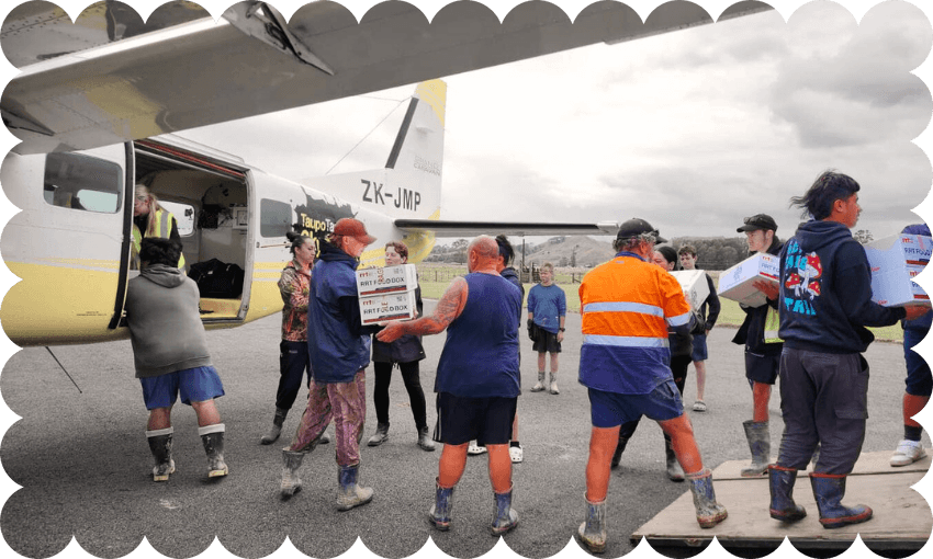 Emergency responders load food into a locked-in community Credit: New Zealand Food Network 

