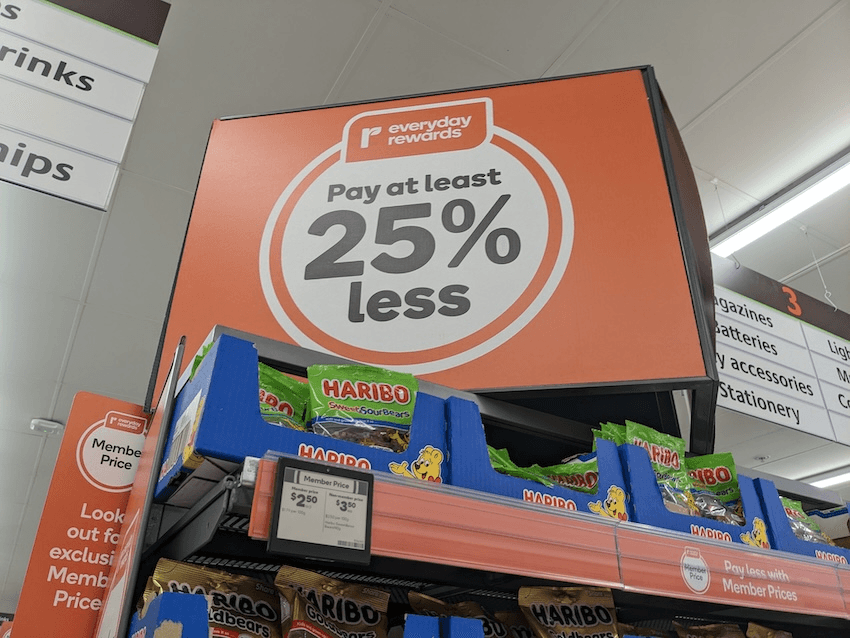 supermarket shelves with a big everyday rewards sign saying 25% less on it