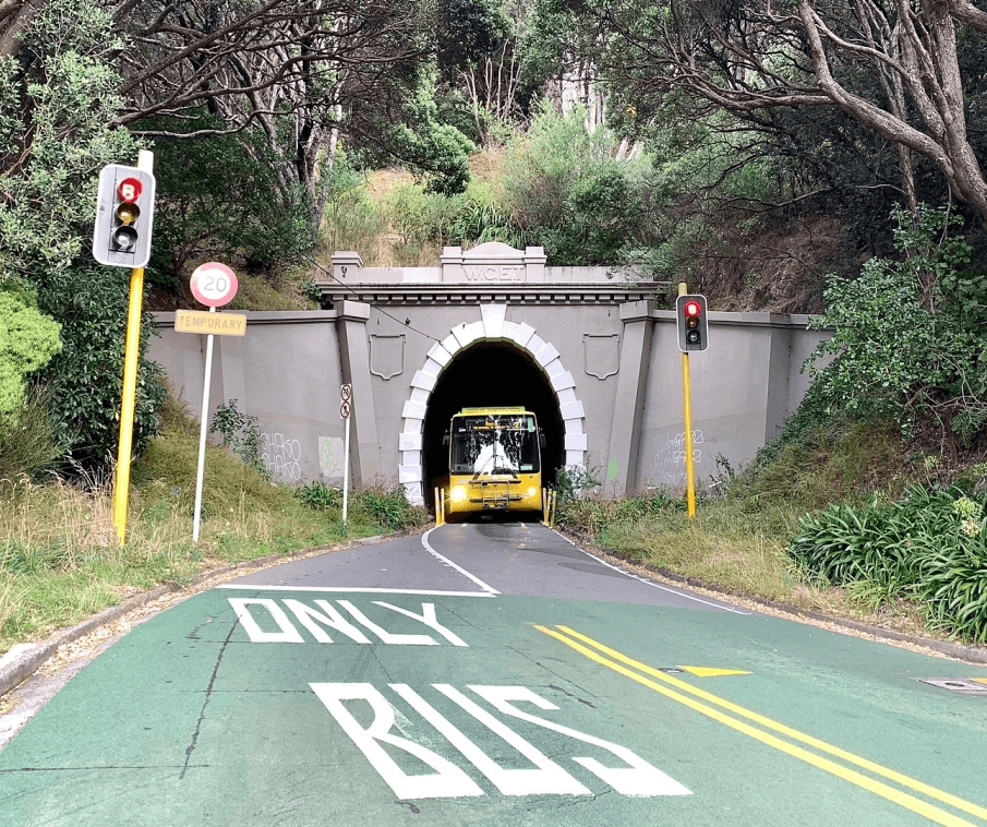 Photo of the entrance to the Hataitai bus tunnel with a yellow bus coming out