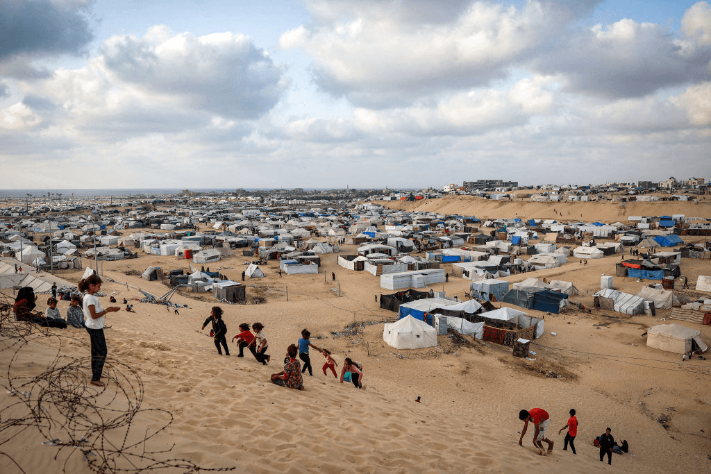 Children play along a slope near a camp housing displaced Palestinians in Rafah in the southern Gaza Strip on April 30, 2024, amid the ongoing conflict in the Palestinian territory between Israel and the militant group Hamas. (Photo by AFP) (Photo by -/AFP via Getty Images)
