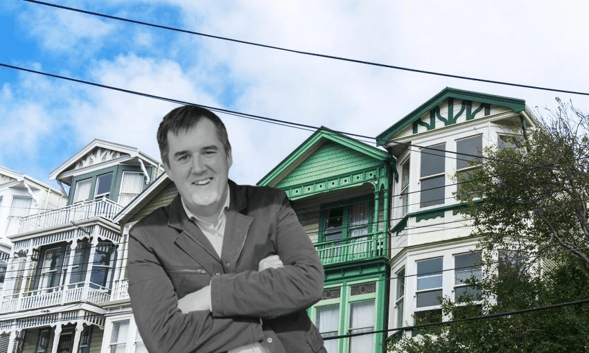 Housing minister Chris Bishop in front of housing 
