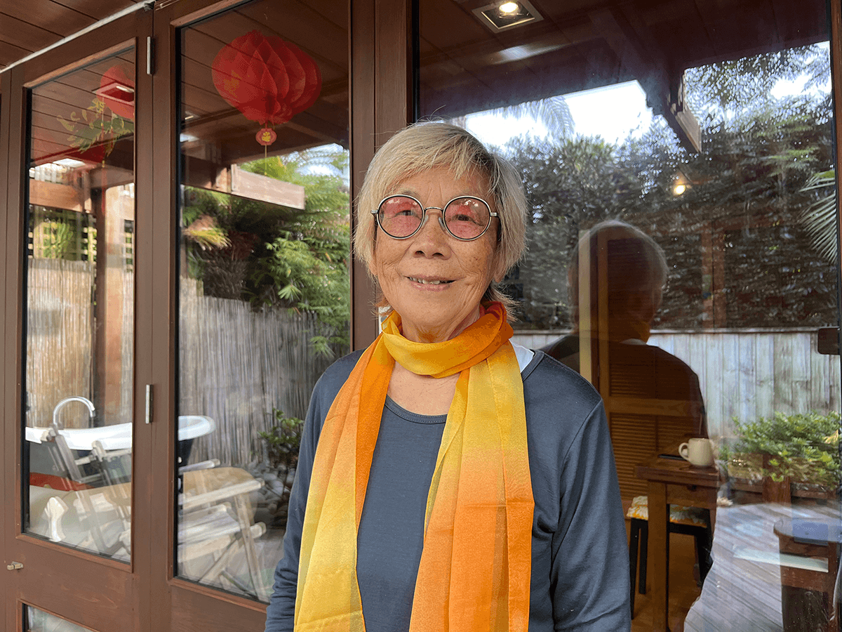 Photo of Wong Liu Shueng wearing an orange silk skarf