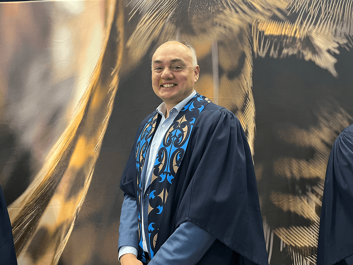 Man in graduation regalia.