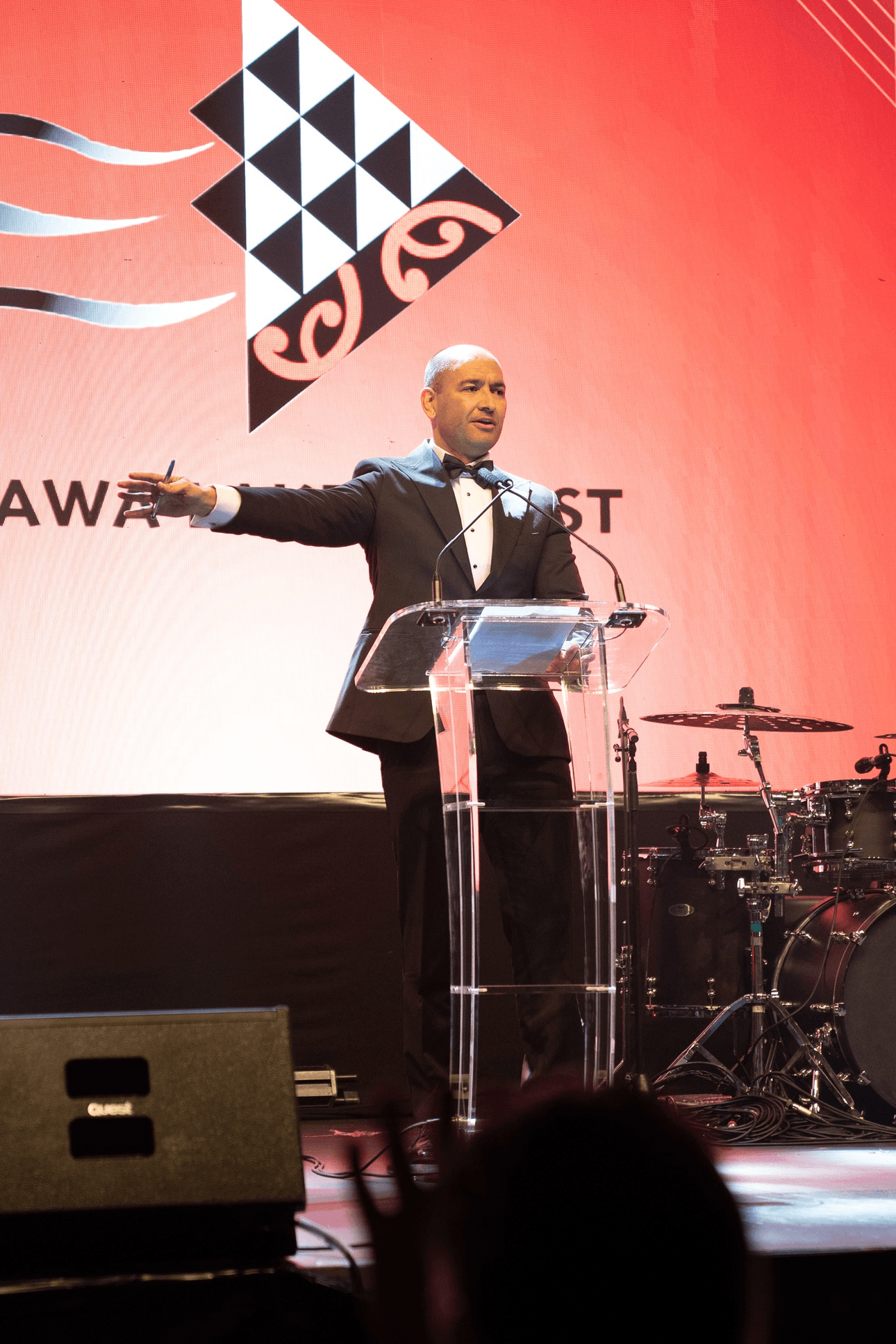 Tama Potaka speaking on stage at Te Arawa Lakes Trust's centennial ball.