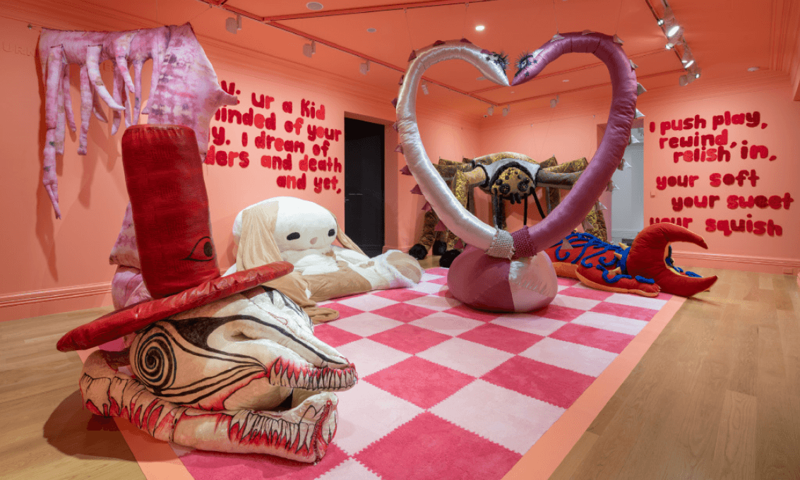 giant plushies in a pink painted gallery