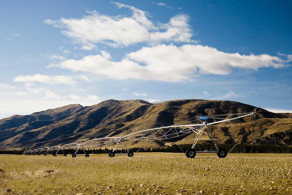 brown hills with a big metal irrigator in the foreground 