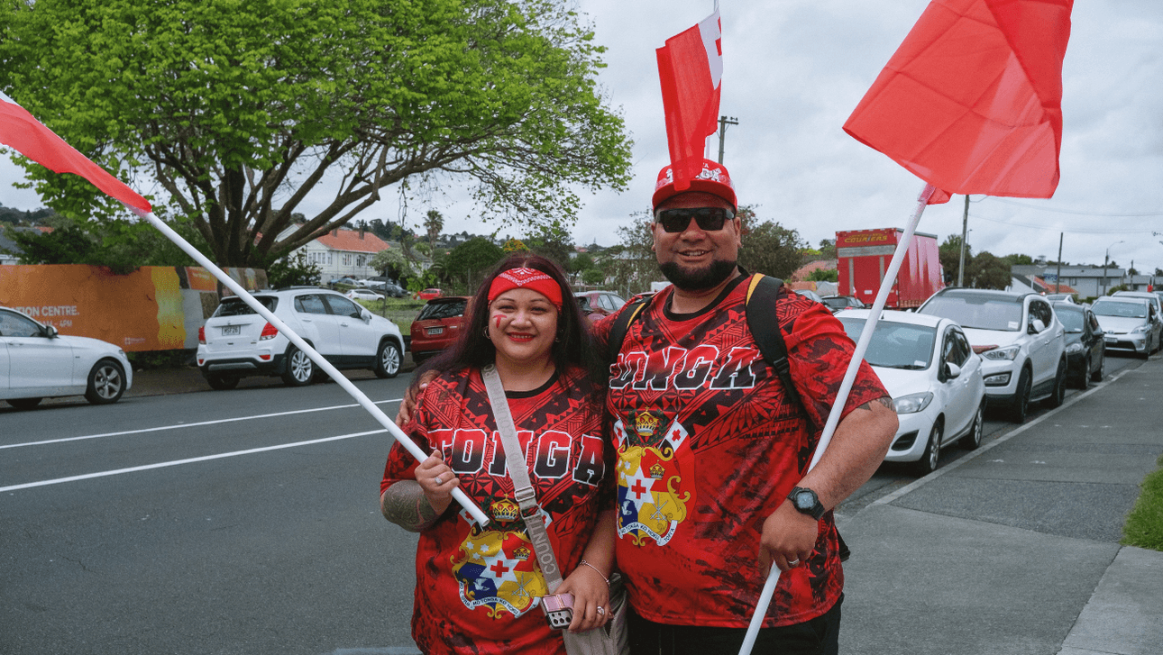 A couple wearing t-shirts with "TONGA" on them