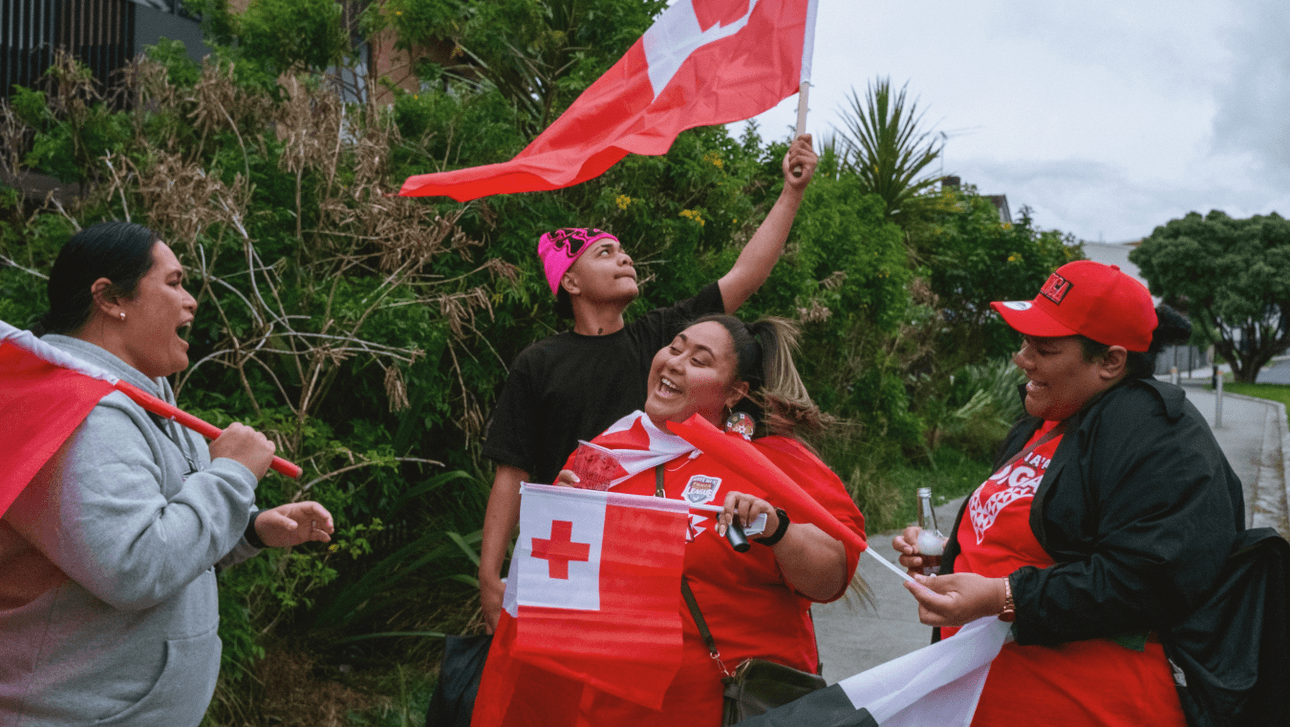 group of four yong women with Tongan flags