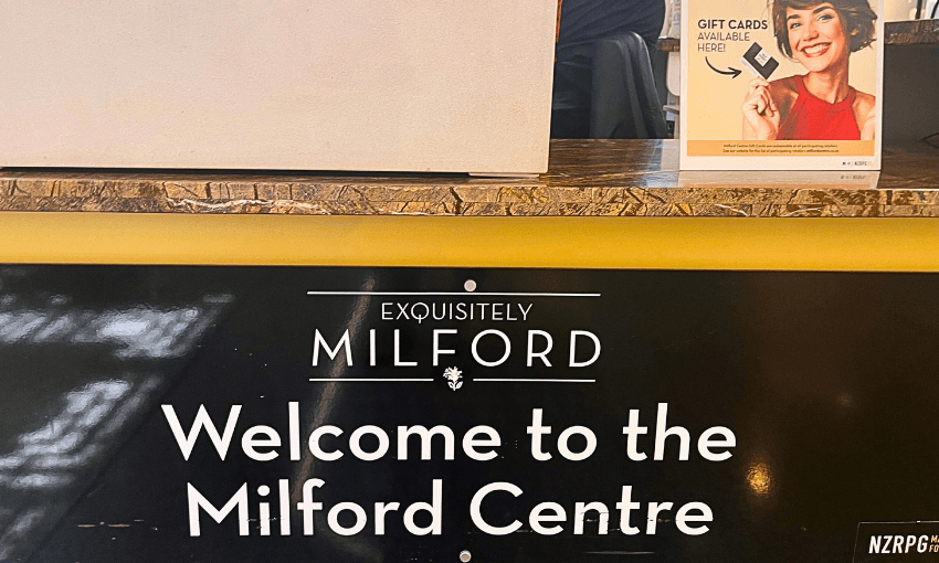 A black and yellow sign reads "Welcome to the Milford Centre" with an elegant design. Above it, the words "Exquisitely Milford"