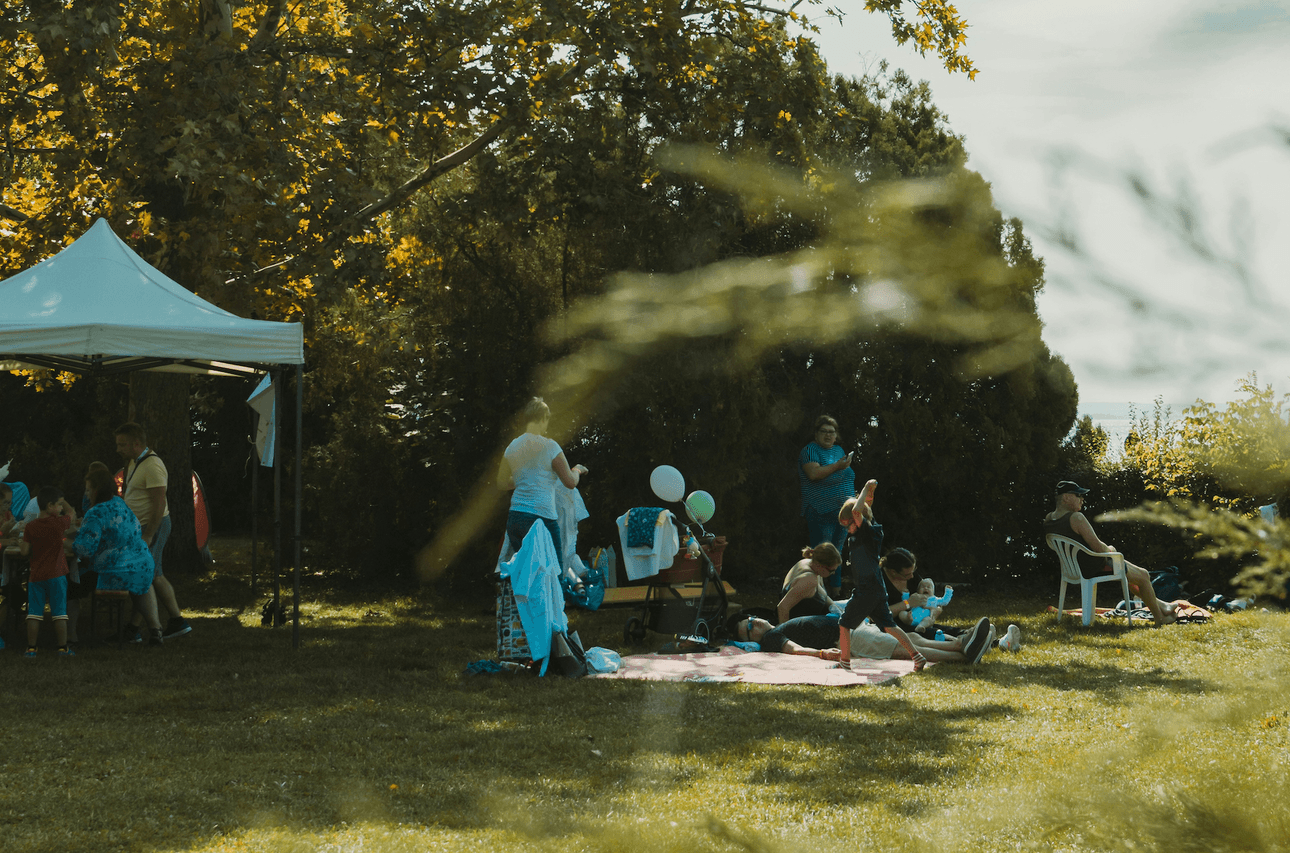 people, probably a family group, lying about on grass