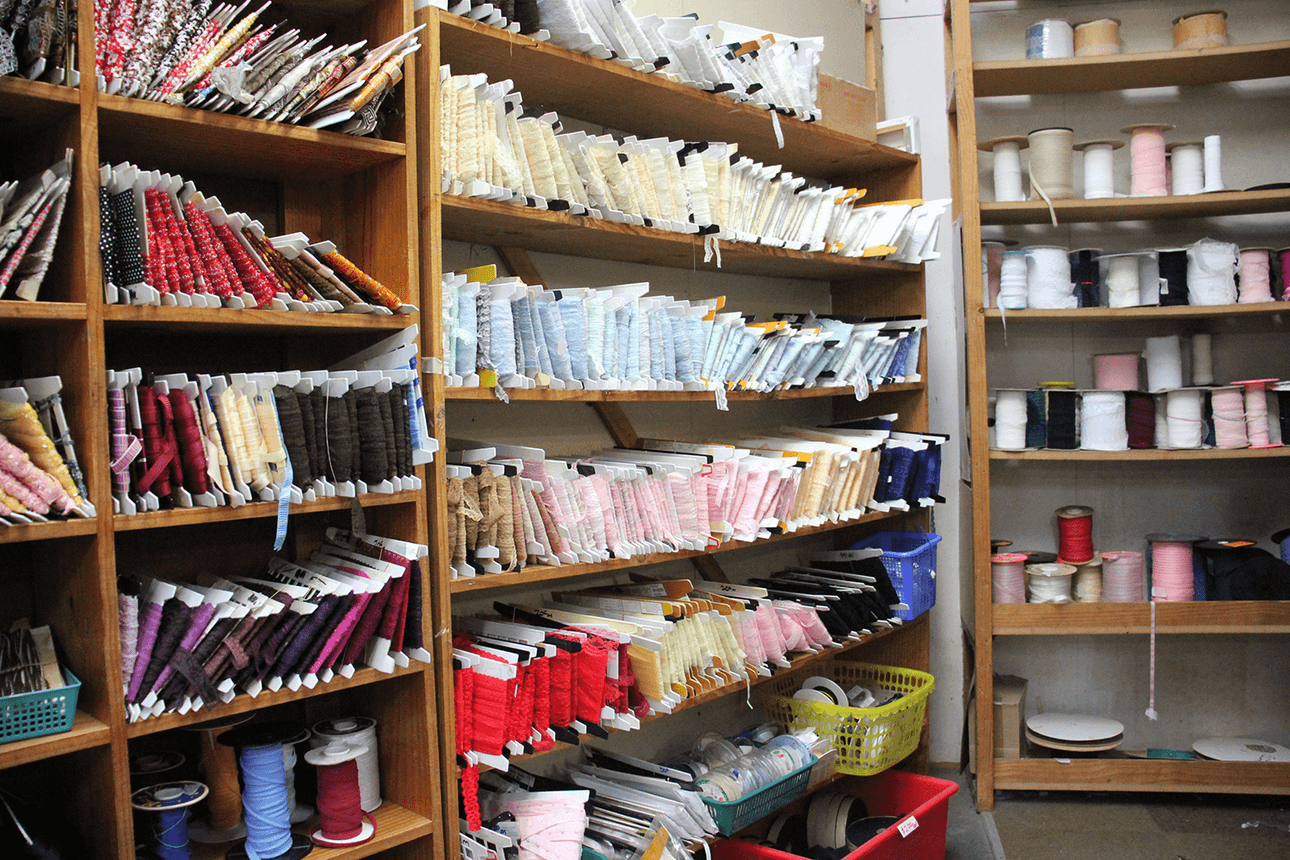 Trims, lace edging and webbing stacked on shelves