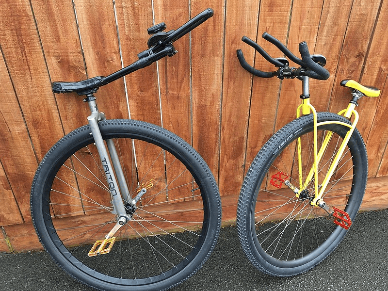 Left: Ken Looi's unicycle for the world record attempt. A grey unicyle with a long handlebar. Right: The V-frame unicycle that Guinness wouldn't allow. The frame is yellow. 