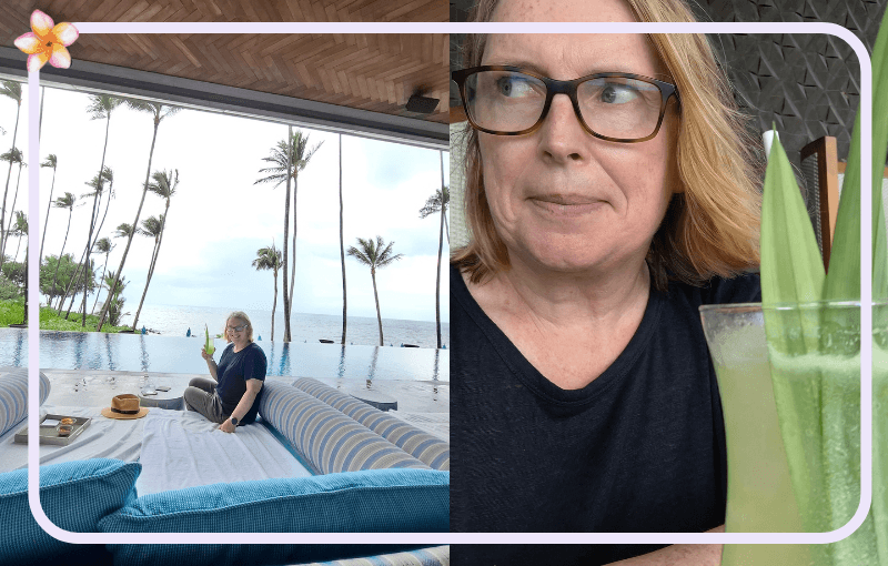 A woman with glasses sits on a cushioned outdoor lounge by an infinity pool, holding a drink. The pool overlooks a tropical beach with palm trees. Inset shows her close-up, smiling and holding a tall green beverage.