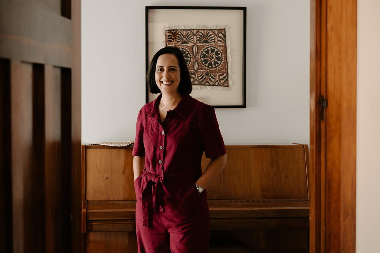 woman in red jumpsuit standing in hallway