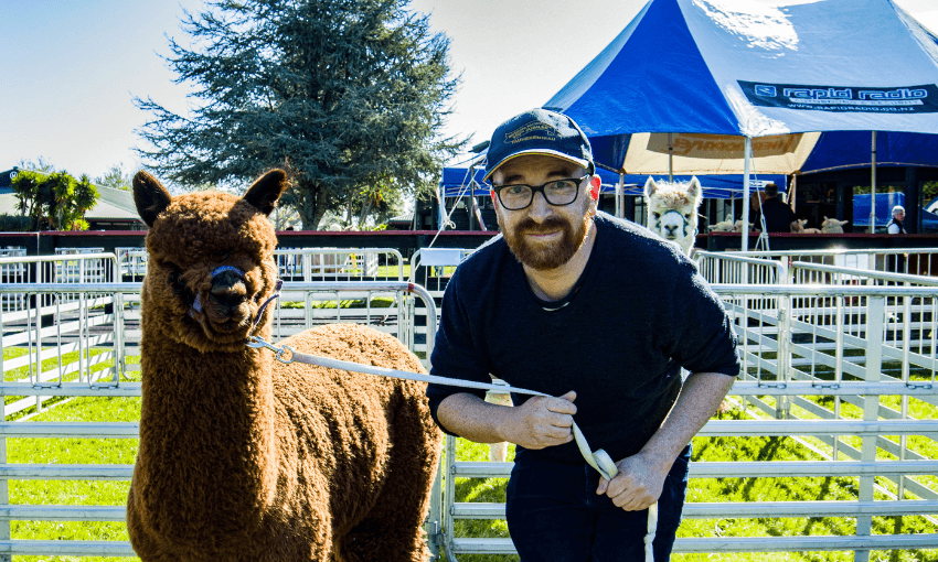 A photo of author Duncan Sarkies next to an alpaca.