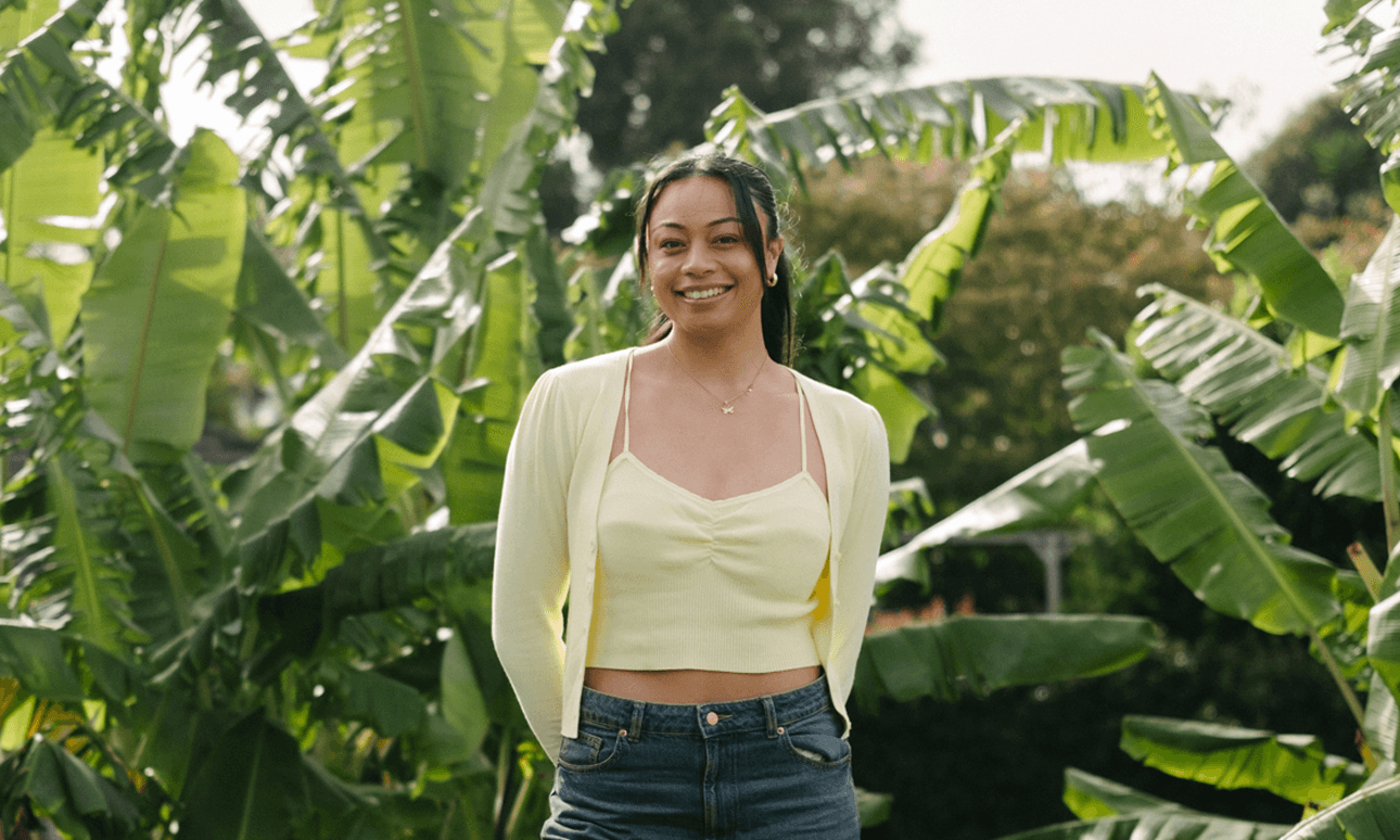 Symone Tafuna’i standing in front of banana plams