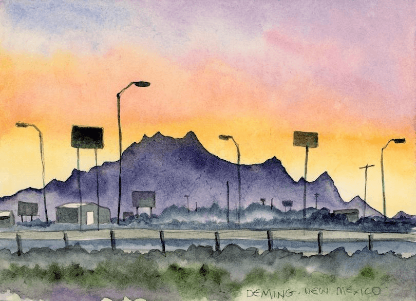 Watercolour painting of a skyline featuring silhouetted lamp posts and billboards against a sunset in Deming, New Mexico. Distant purple mountains contrast with a colorful sky of pink, orange, and yellow hues.