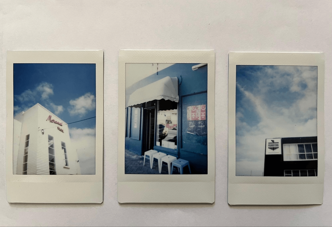 Three polaroids: one showing the white front of Maranui Cafe, the second showing four white stools in front of a cafe entrance, the last showing the Parrotdog sign on the top corner of a black building