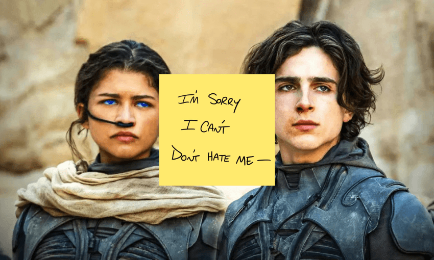 Two individuals wearing desert attire with serious expressions stand side by side. A yellow sticky note on the image reads, "I'm sorry I can't don't hate me." The background features rocky terrain.