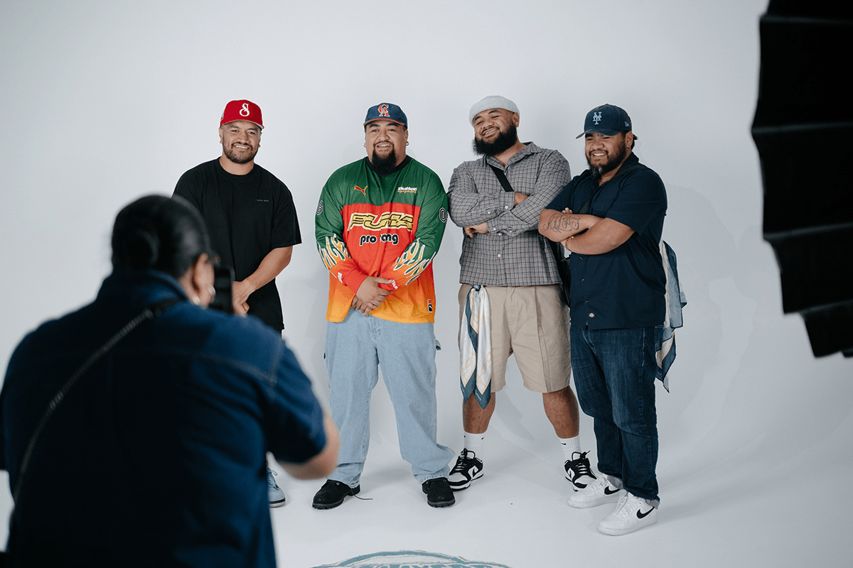 four men being photographed wearing streetwear