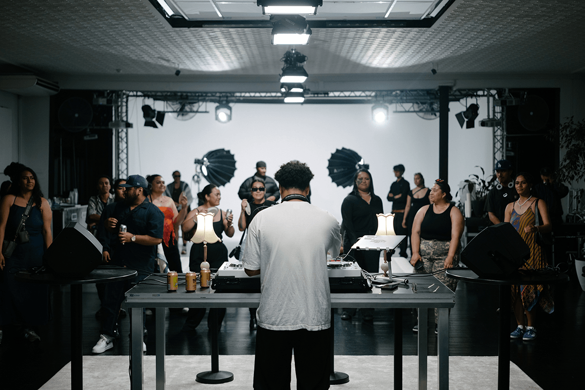 man djing from behind with crowd in front