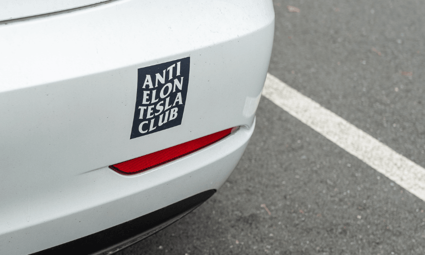 bumper of a white car with sticker saying "Anti Elon Tesla Club"