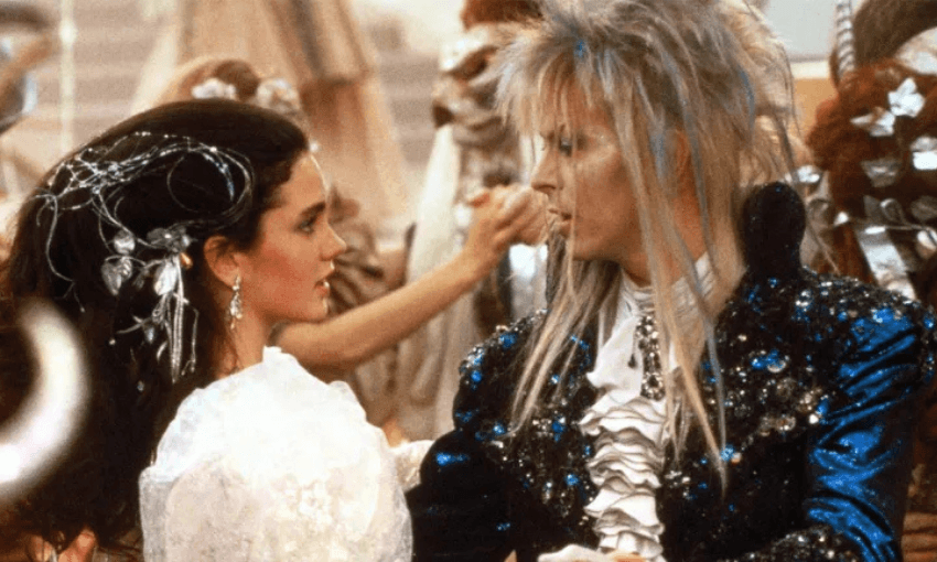 A film still of Jennifer Connolly and David Bowie dancing in a scene in The Labyrinth film. 
