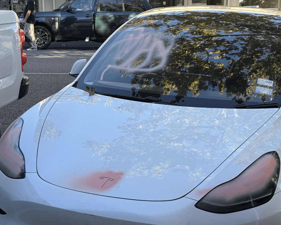 white tesla with pink spray paint