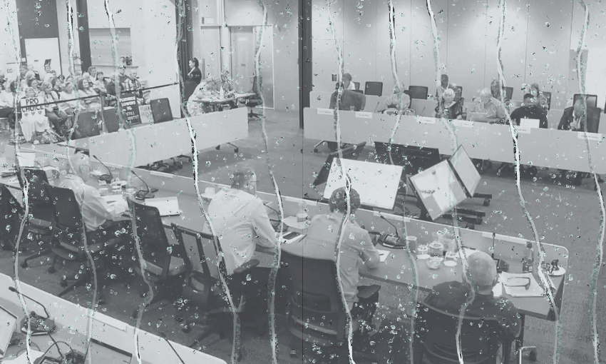 a meeting room filled with people seated at desks in a U shape. Dripping water is overlaid on top.